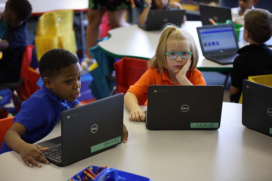 students and teacher working in classroom