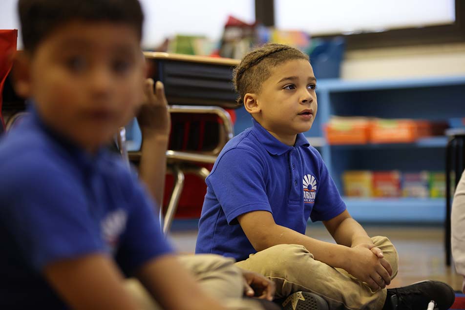 student in classroom smiling at camera